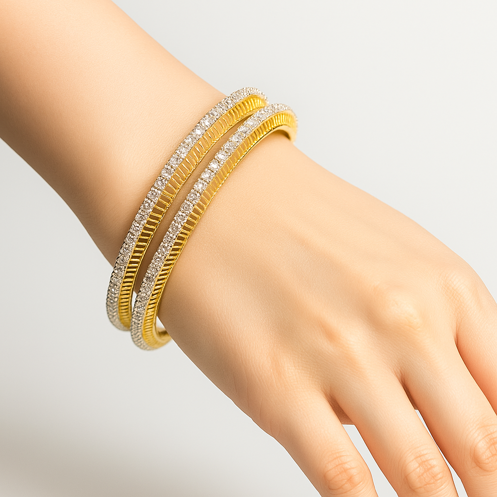 Gold and lab grown diamond bangles on a hand against a light gray background
