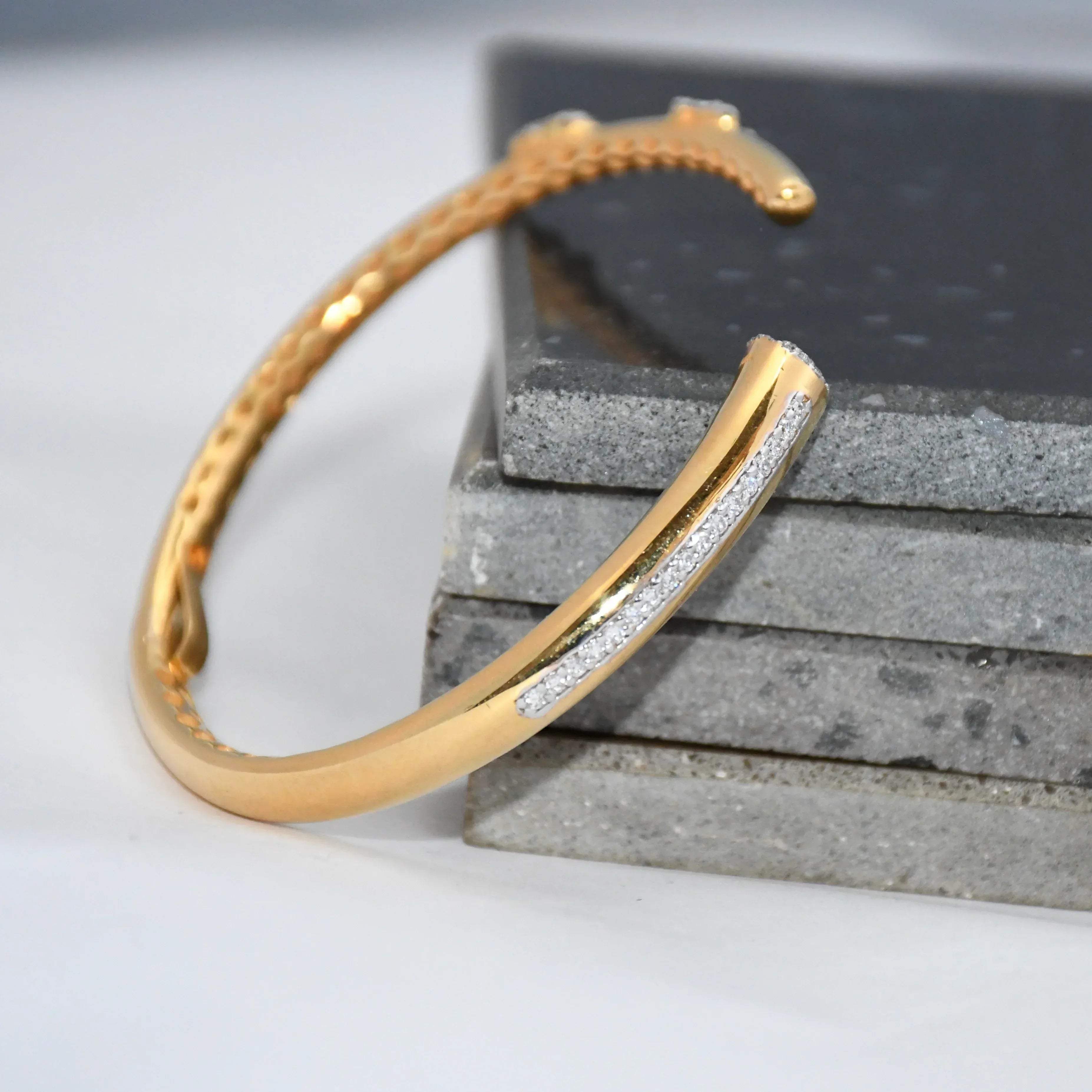 Gold bracelet with embedded lab grown diamonds on a textured surface