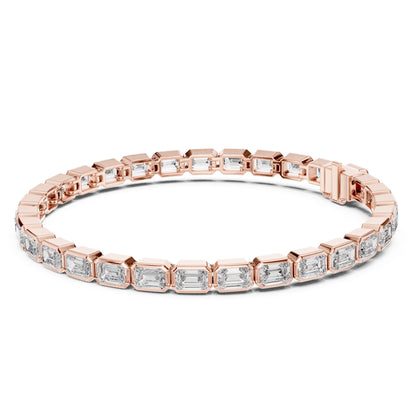 Rose gold bracelet with emerald-cut lab grown diamond accents on a white background.