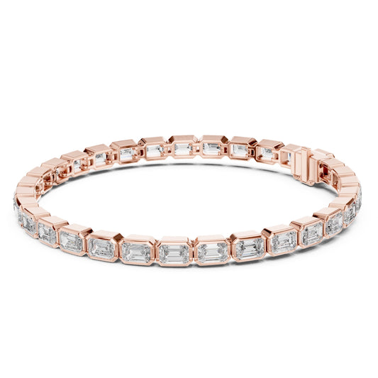Rose gold bracelet with emerald-cut lab grown diamond accents on a white background.