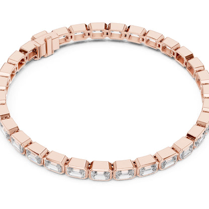Rose gold bracelet with emerald-cut lab grown diamond accents on a white background.