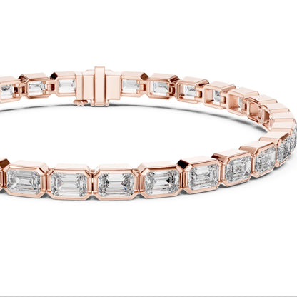 Rose gold bracelet with emerald-cut lab grown diamond accents on a white background
