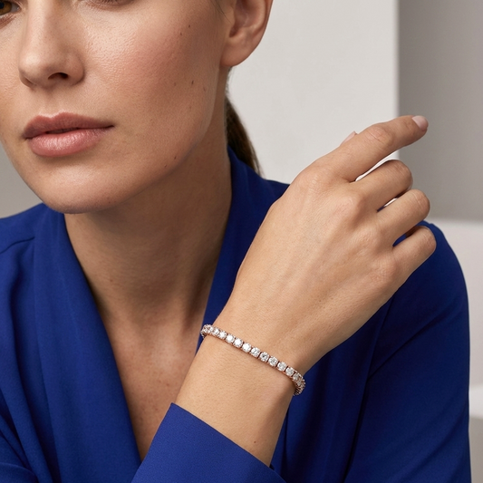 Woman wearing a lab grown diamond bracelet on a neutral background