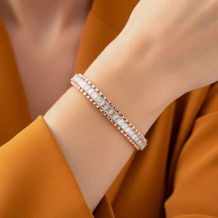 Rose gold bracelet with lag grown diamonds on a wrist against an orange background