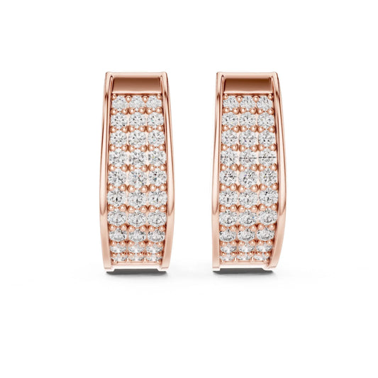 Rose gold huggies/hoops earrings with lab grown diamonds shown on a white surface.