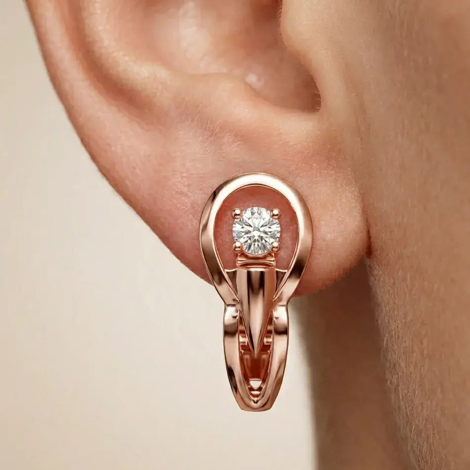 Rose gold earring with a lab grown diamond on an ear against a beige background