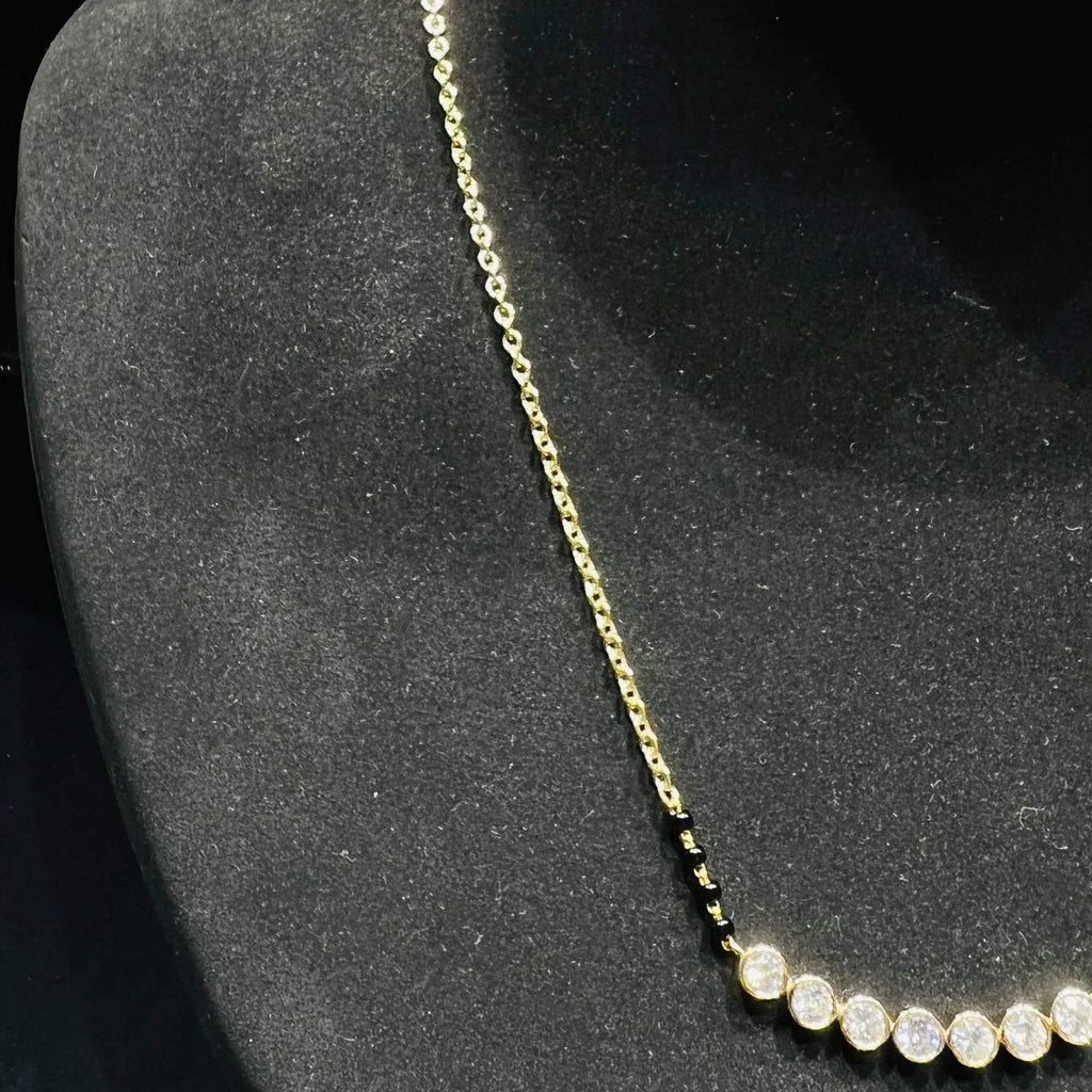 Gold and lab grown diamonds mangalsutra on a black mannequin bust