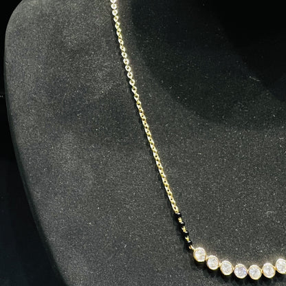 Gold and lab grown diamonds mangalsutra on a black mannequin bust