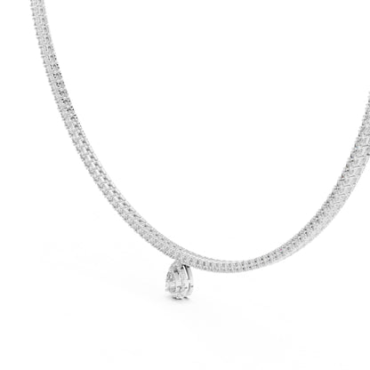 White gold and lab grown diamond tennis necklace with a small pear shape lab grown diamond pendant on a white background