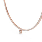 Gold and lab grown diamond tennis necklace with a small pear shape lab grown diamond pendant on a white background