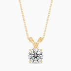 Yellow gold necklace with a round solitaire lab grown diamond pendant on a white background