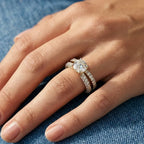 Close-up of a hand wearing a lab grown diamond ring on a blue fabric background
