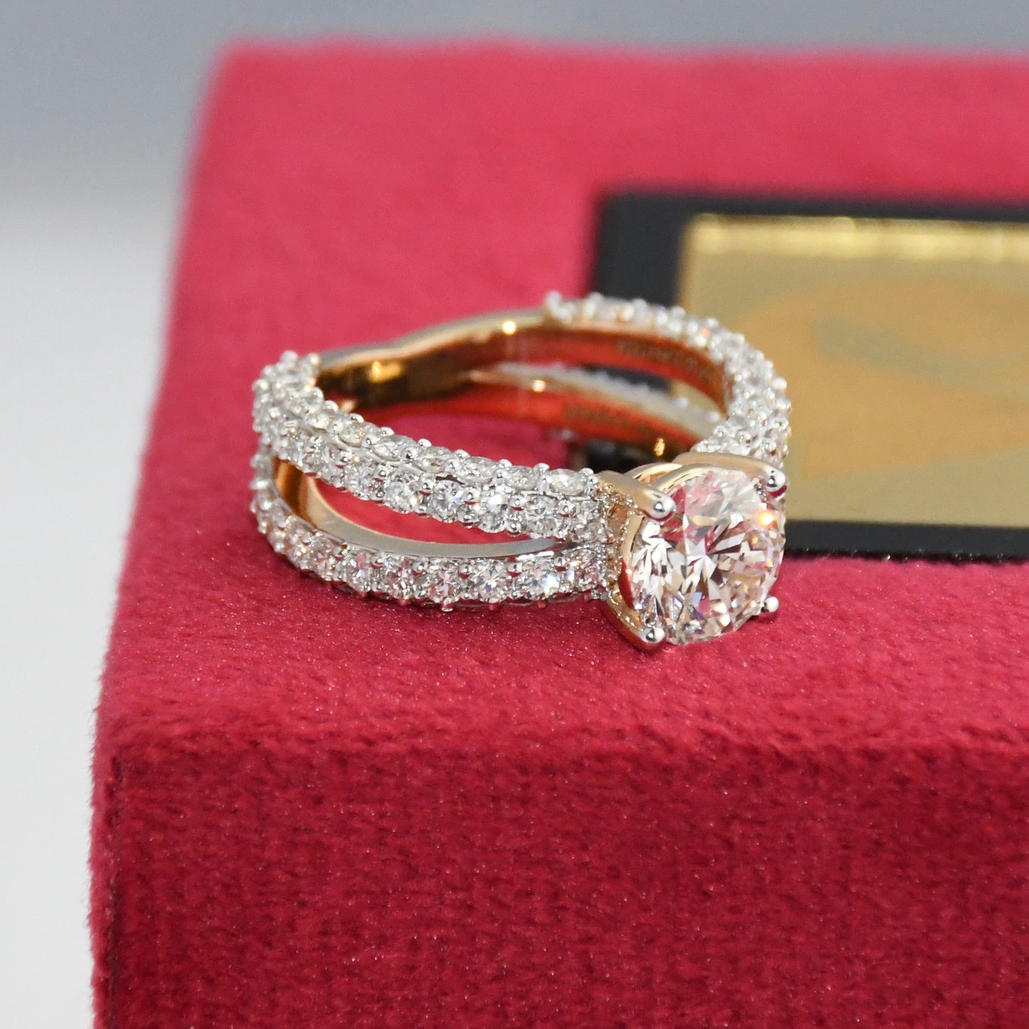 Lab grown diamond ring on a red jewelry box with a blurred background