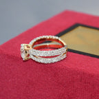 Gold and lab grown diamond ring on a red jewelry box with a blurred background