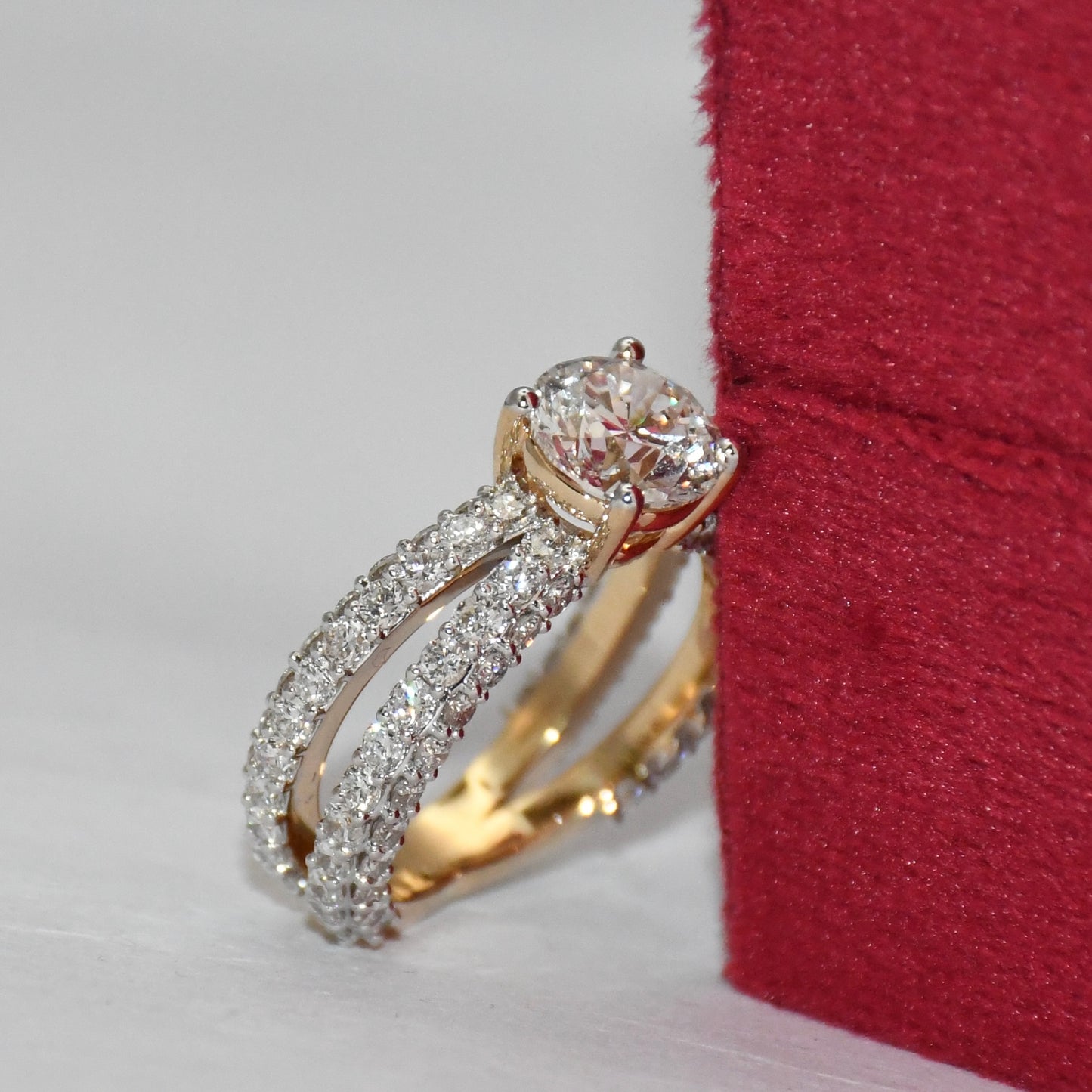 Gold ring with lab grown diamonds on a red and white background