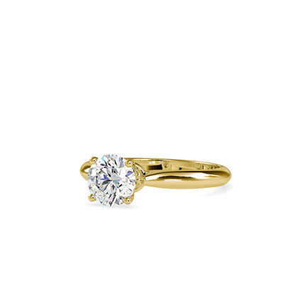 Gold ring with a solitaire lab grown diamond on a white background