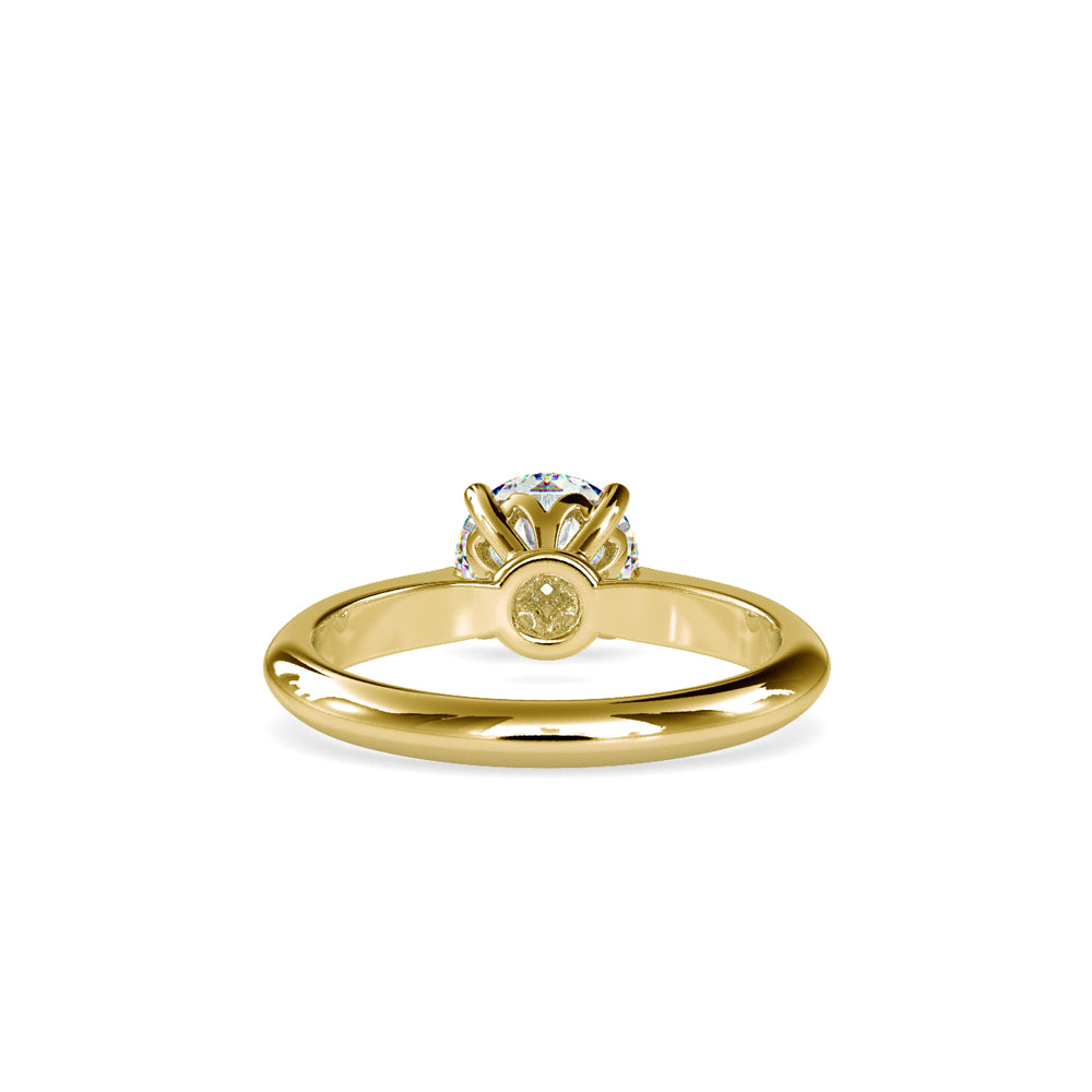 Gold ring with a solitaire lab grown diamond on a white background