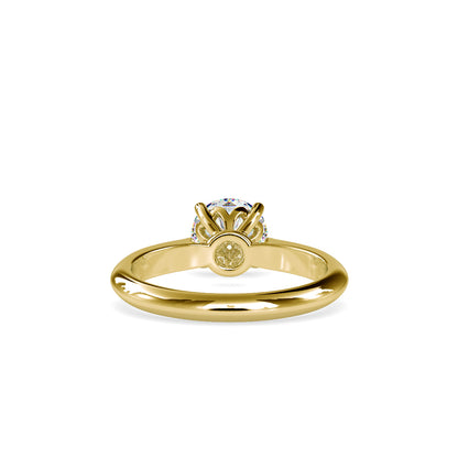 Gold ring with a solitaire lab grown diamond on a white background