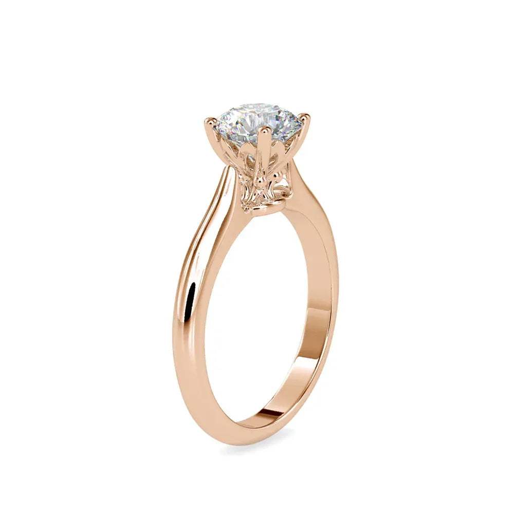 Gold ring with a solitaire lab grown diamond on a white background