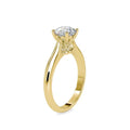 Gold ring with a solitaire lab grown diamond on a white background