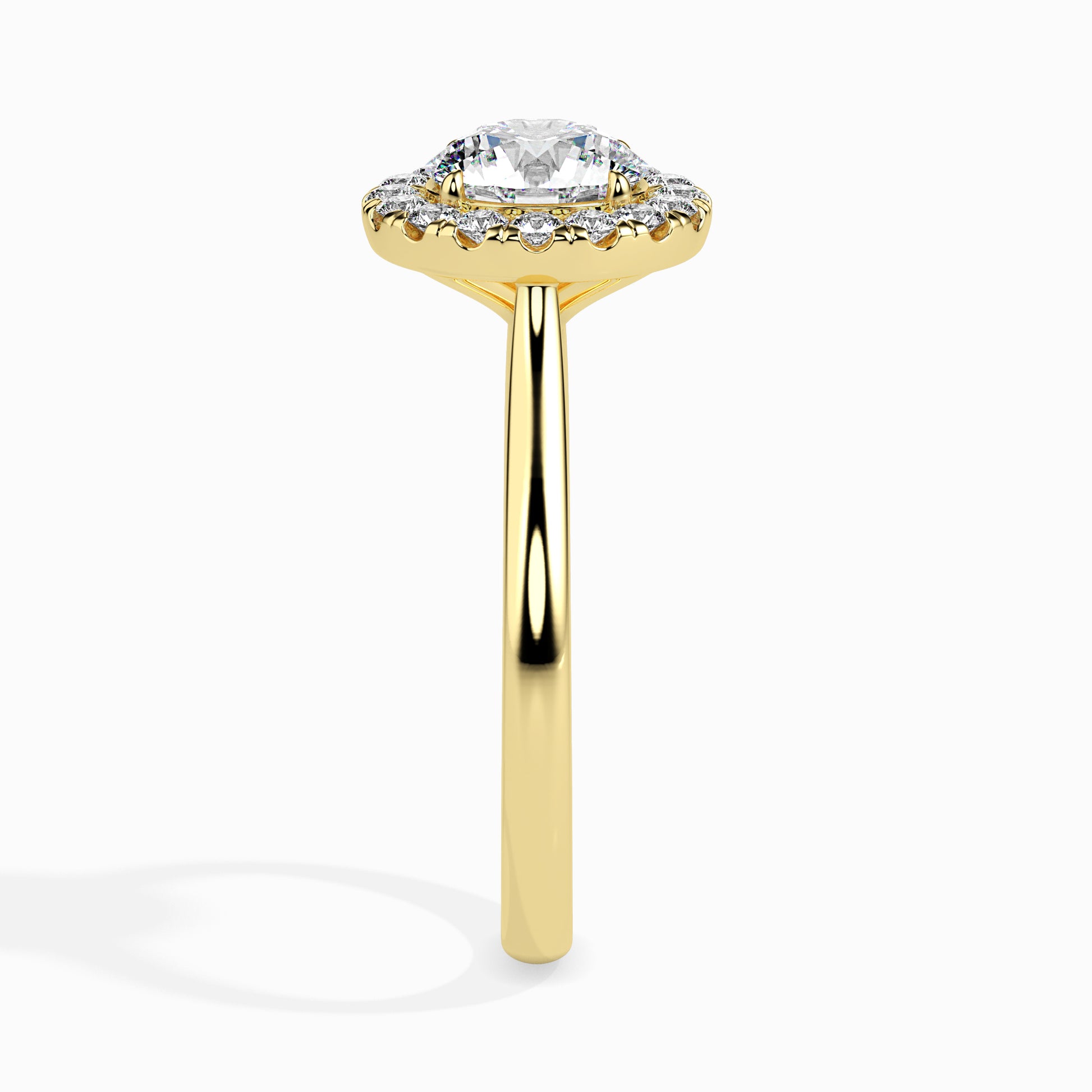 Gold ring featuring a round brilliant-cut lab grown diamond at the center, surrounded by a sparkling halo of smaller round diamonds, displayed on a light background.