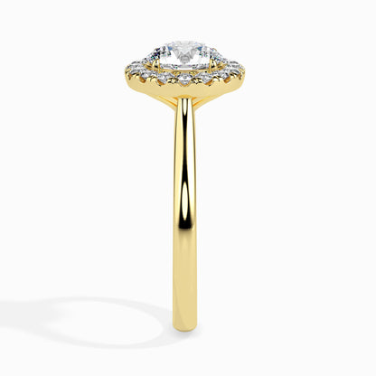 Gold ring featuring a round brilliant-cut lab grown diamond at the center, surrounded by a sparkling halo of smaller round diamonds, displayed on a light background.