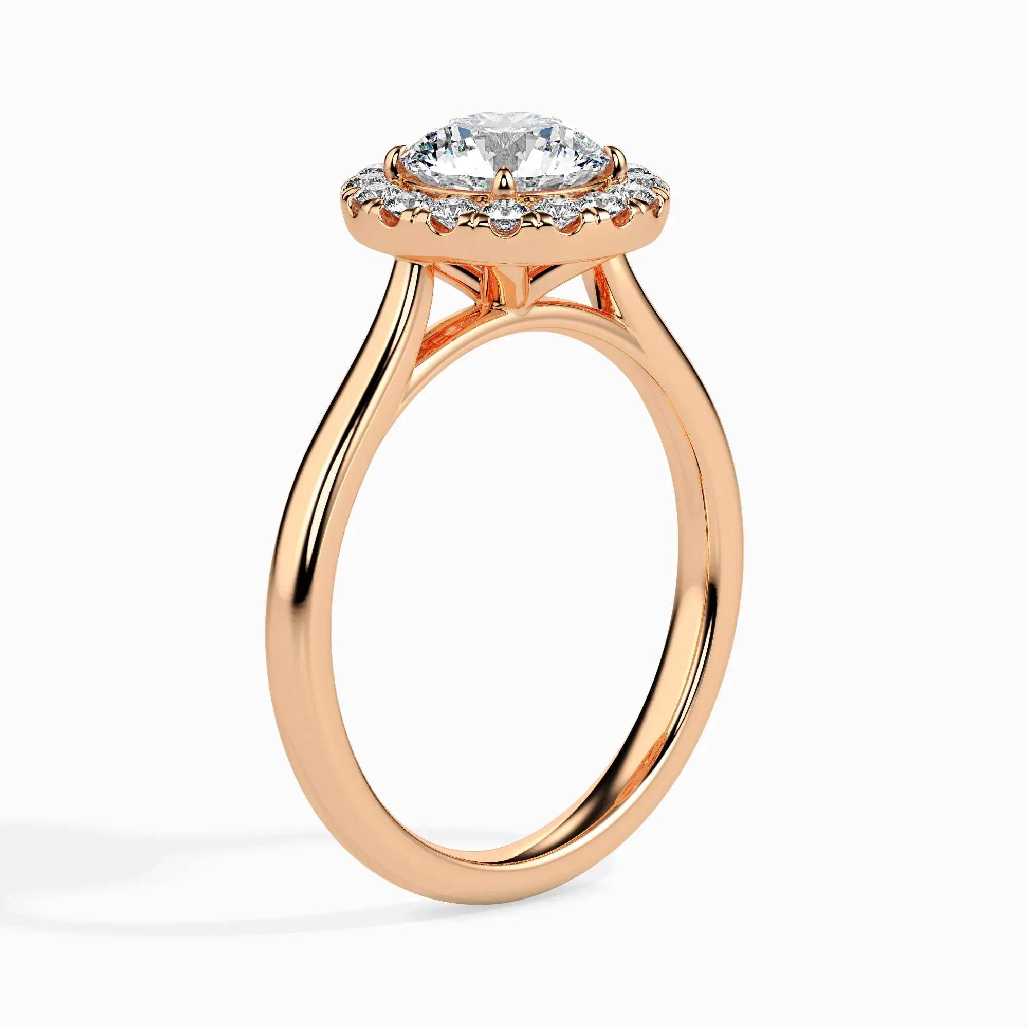 Gold ring featuring a round brilliant-cut lab grown diamond at the center, surrounded by a sparkling halo of smaller round diamonds, displayed on a light background.