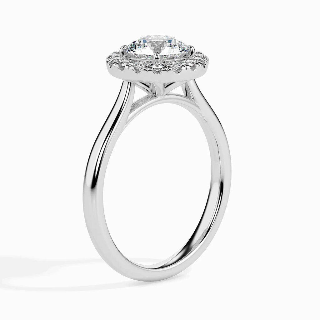 Gold ring featuring a round brilliant-cut lab grown diamond at the center, surrounded by a sparkling halo of smaller round diamonds, displayed on a light background.