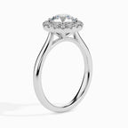 Gold ring featuring a round brilliant-cut lab grown diamond at the center, surrounded by a sparkling halo of smaller round diamonds, displayed on a light background.