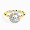 Gold ring featuring a round brilliant-cut lab grown diamond at the center, surrounded by a sparkling halo of smaller round diamonds, displayed on a light background.