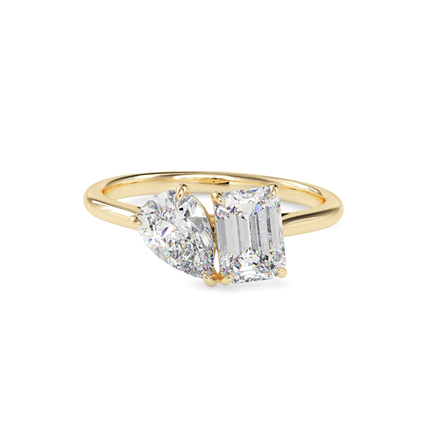 Gold ring with two lab grown diamonds- one pear shape and other baguette shape, on a white background