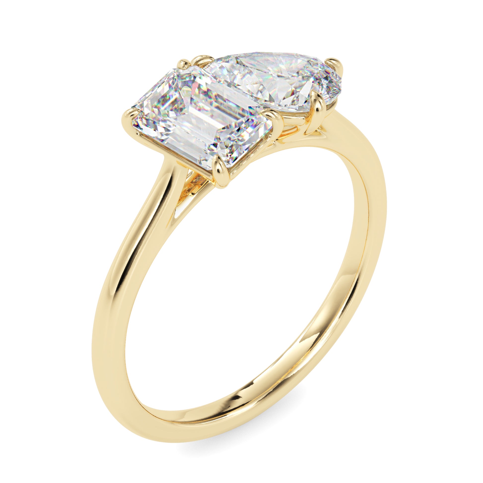 Gold ring with two lab grown diamonds- one pear shape and other baguette shape, on a white background