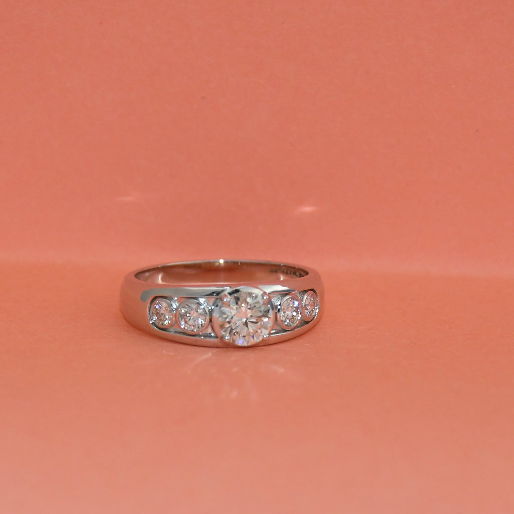 White gold ring with lab diamonds on a pink background