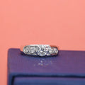 Lab diamond ring on a purple surface with a pink background
