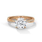 Gold and lab grown diamond ring on a white background.