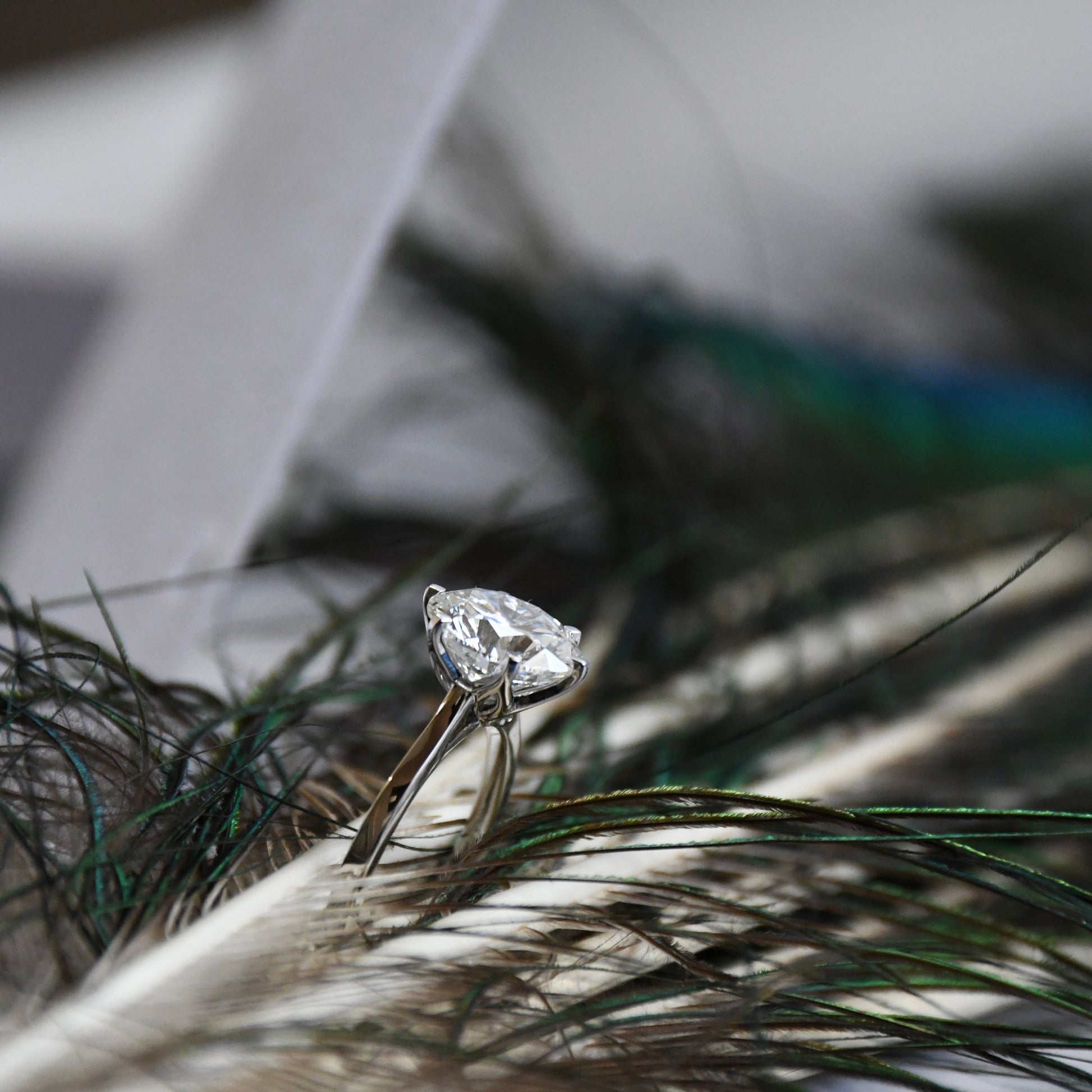 Lab grown diamond ring on a surface with a blurred background
