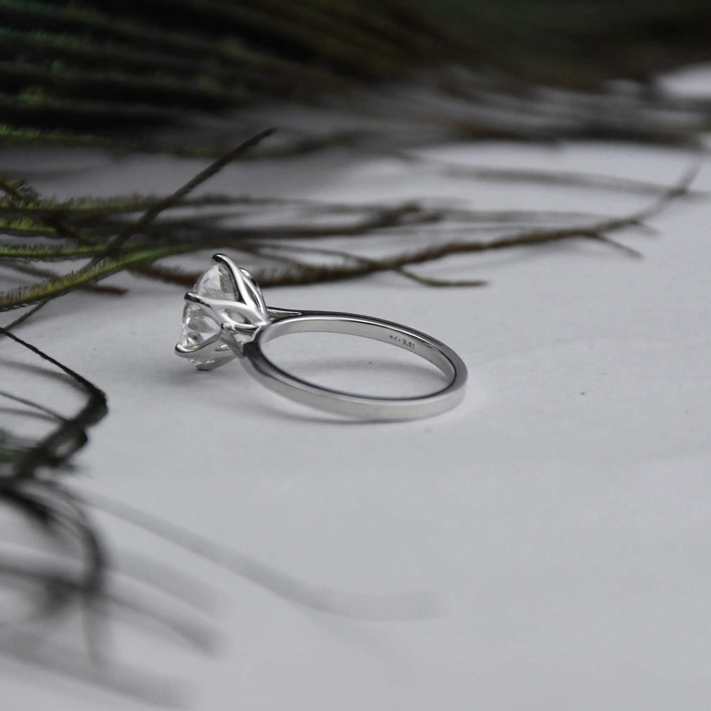White gold ring with a large solitaire diamond on a light background