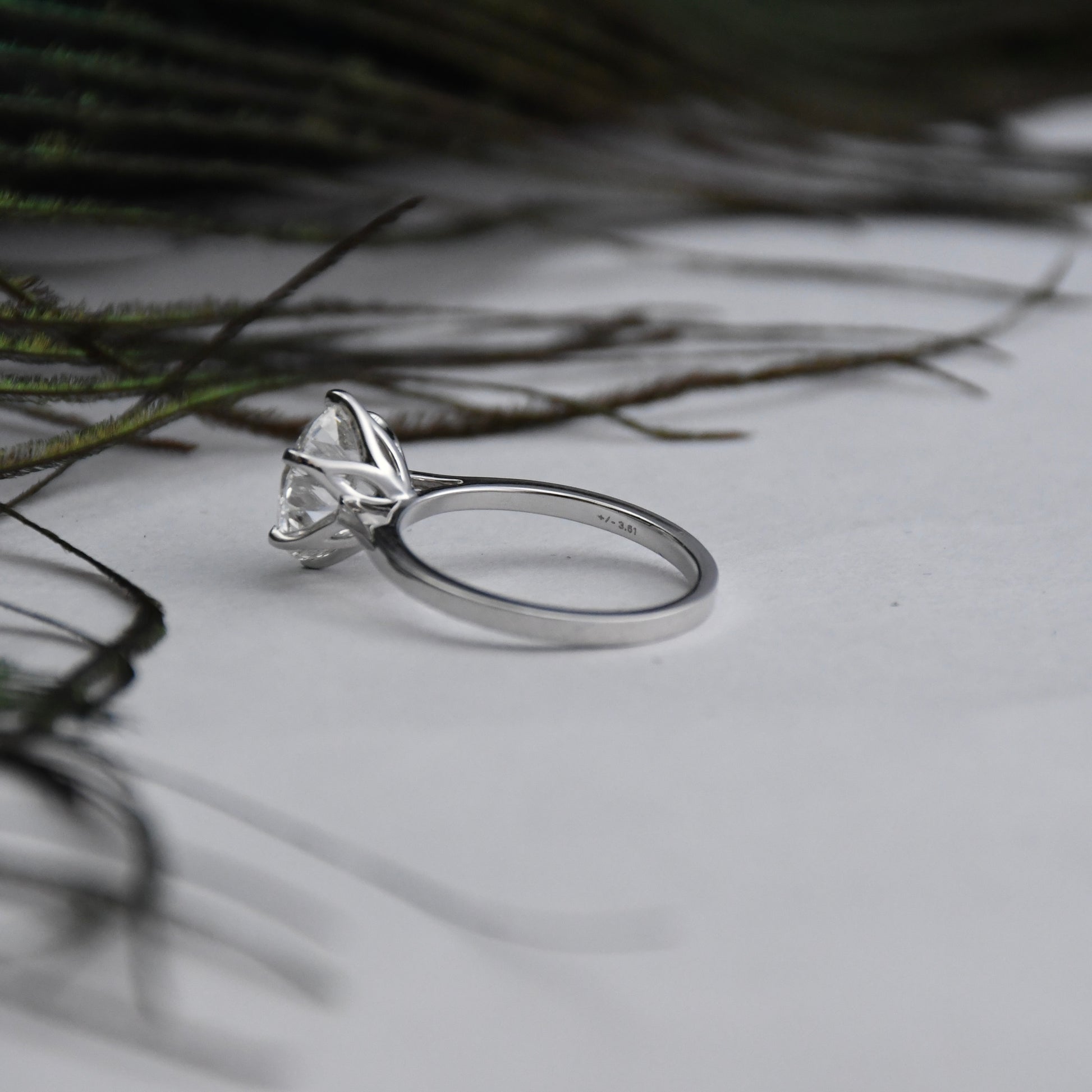 White gold ring with a large solitaire diamond on a light background