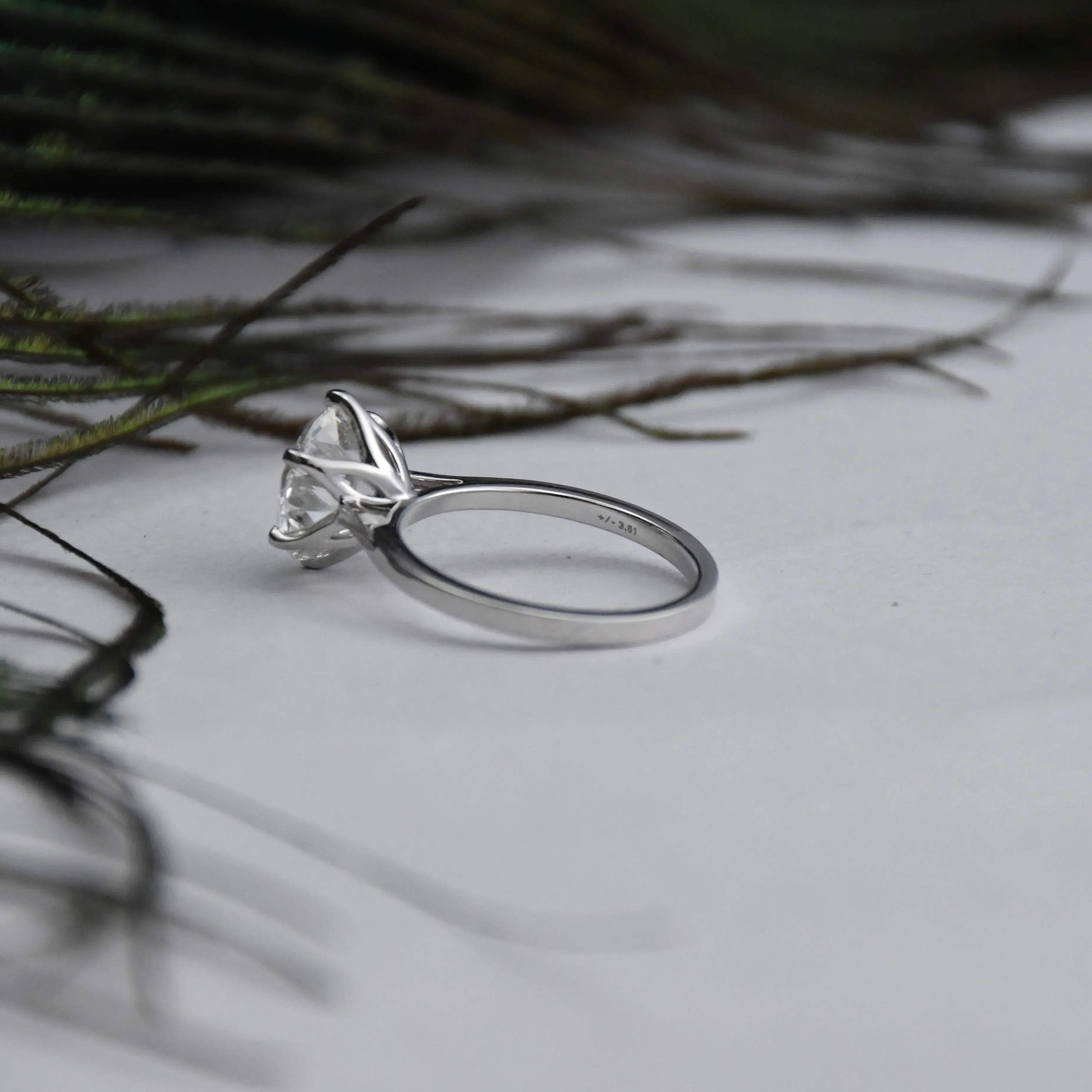White gold ring with a large solitaire diamond on a light background