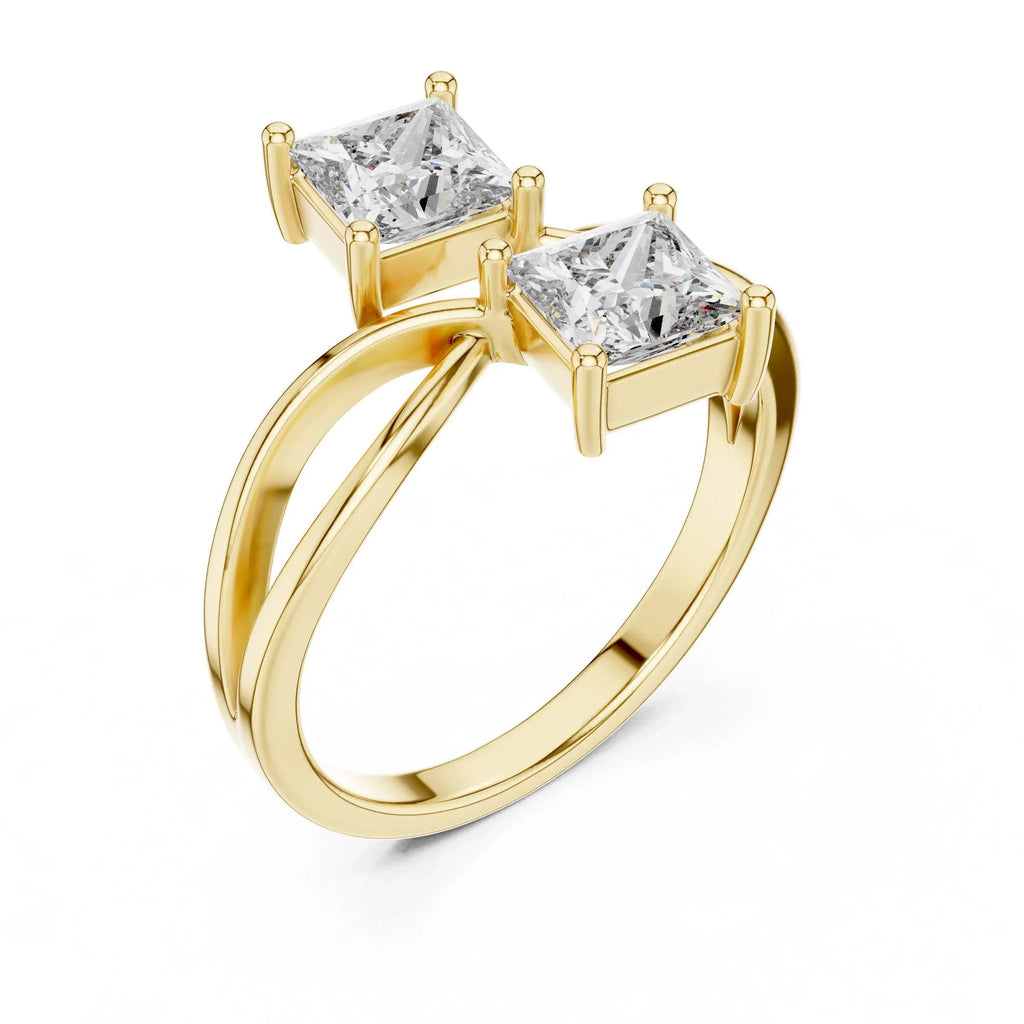 Gold ring with two princess-cut lab grown diamonds on a white background