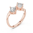 Rose gold ring with two princess-cut lab grown diamonds on a white background