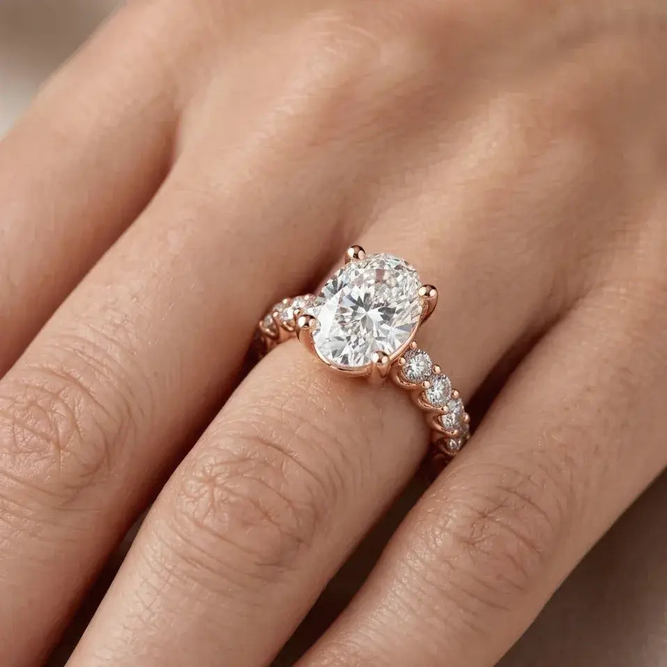 Rose gold ring with a large lab grown diamond on a hand.
