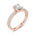 Rose gold ring with a central lab grown diamond and smaller lab grown diamonds on a white background