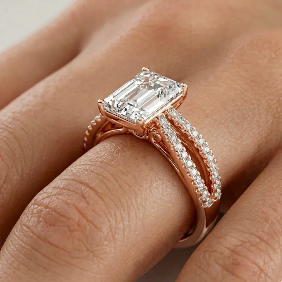 Rose gold ring with a large lab grown diamond with other small round diamonds on a finger
