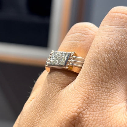 A man's hand displaying a diamond ring on his finger.