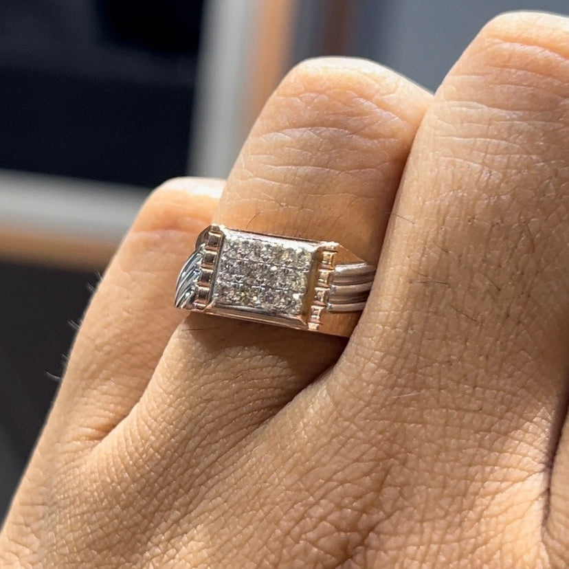 A man's hand displaying a diamond ring on his finger.
