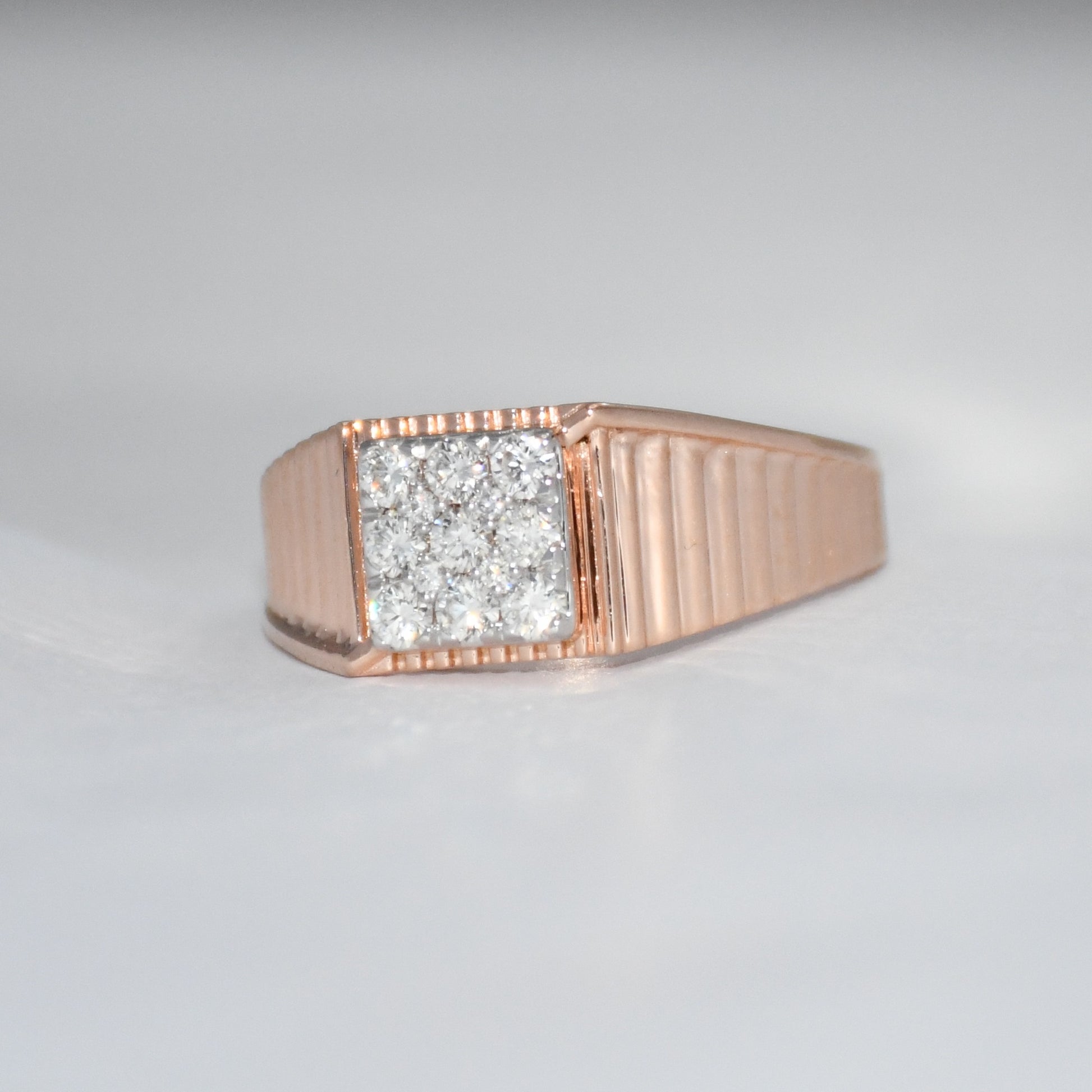 gold ring with diamond on a gray background