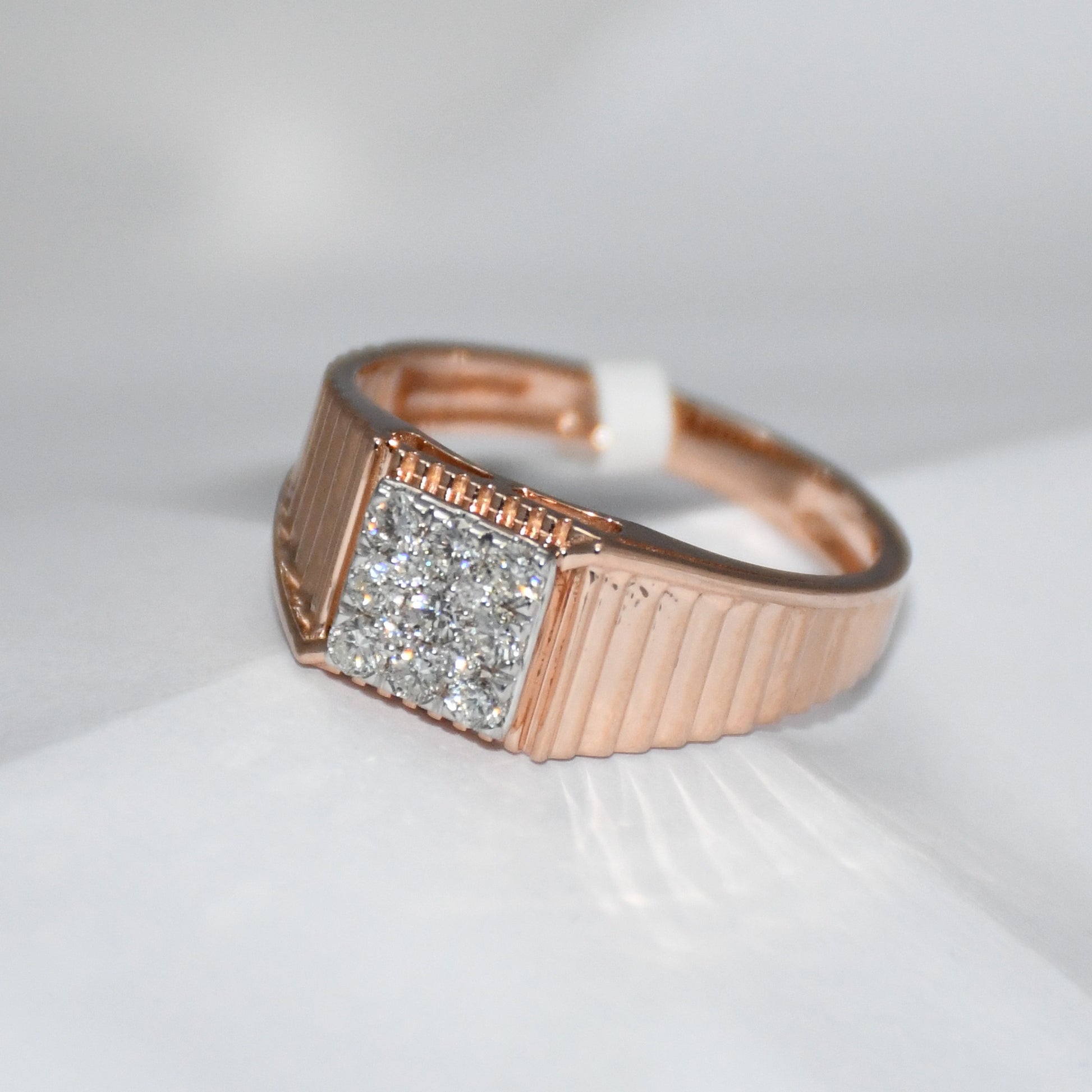 gold ring with diamond accent on a white surface