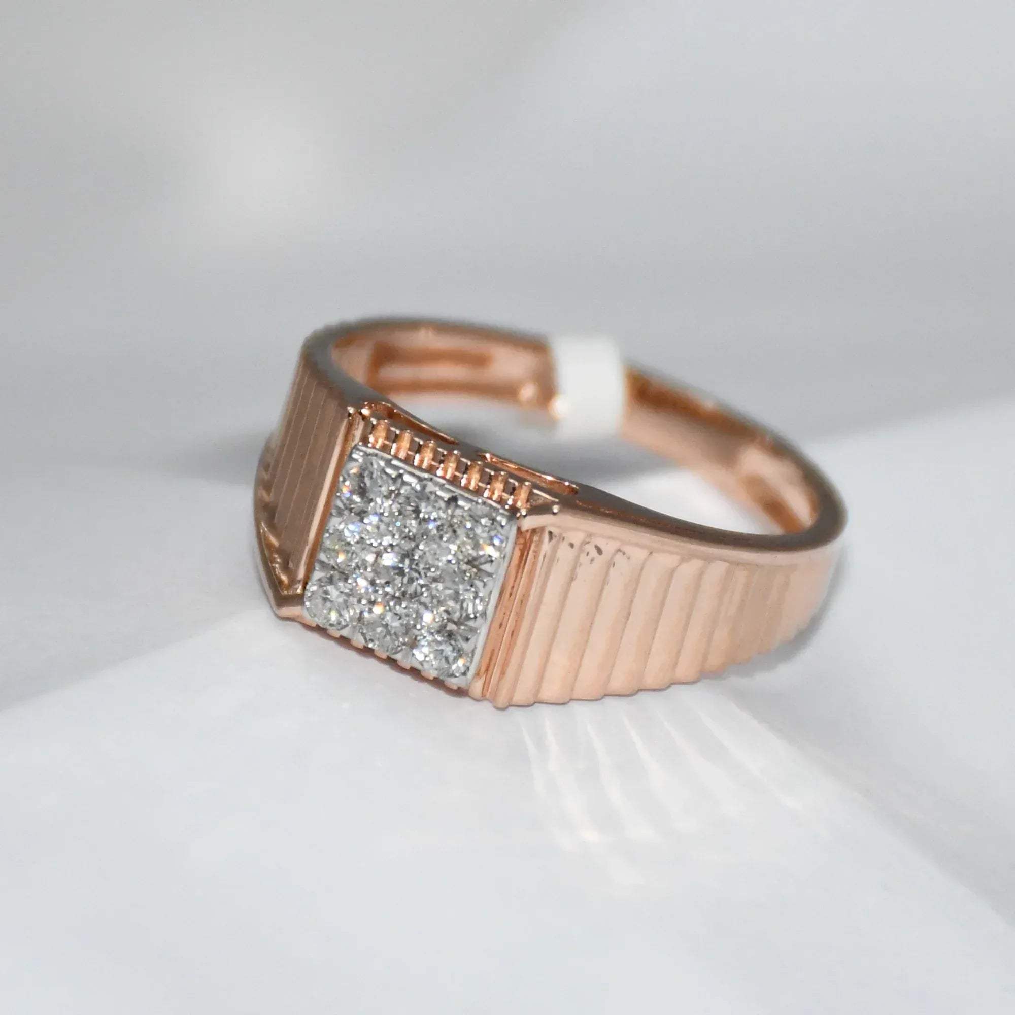 gold ring with diamond accent on a white surface