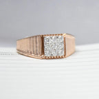 gold ring with diamonds on a light gray background